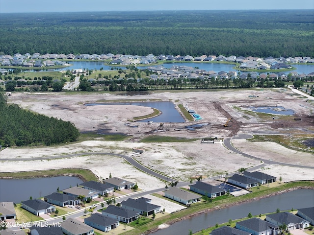 bird's eye view with a water view, a residential view, and a view of trees