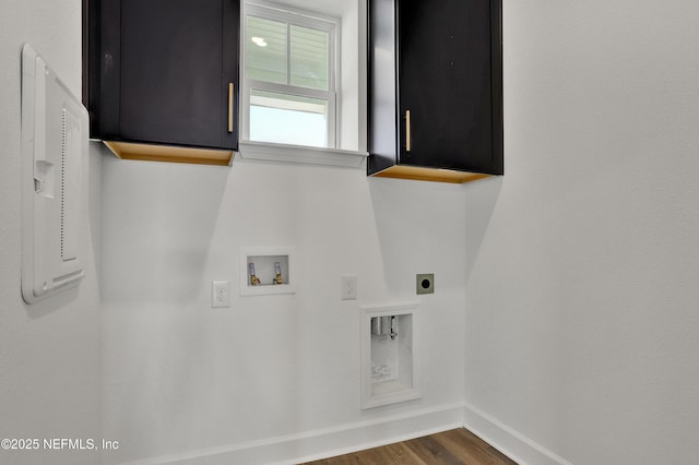 clothes washing area featuring hookup for a washing machine, dark wood-style flooring, baseboards, cabinet space, and electric dryer hookup