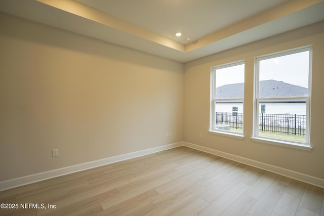 spare room featuring baseboards, recessed lighting, and light wood-style floors