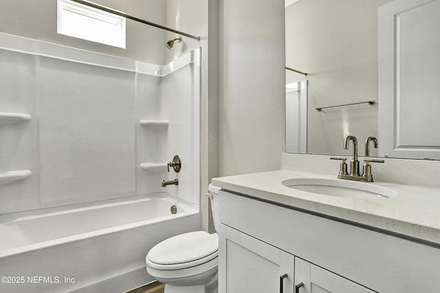 bathroom with washtub / shower combination, vanity, and toilet