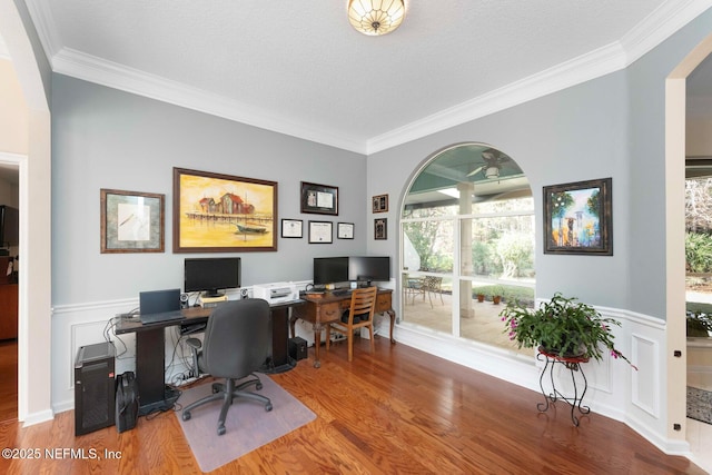 office with crown molding, a textured ceiling, and hardwood / wood-style flooring