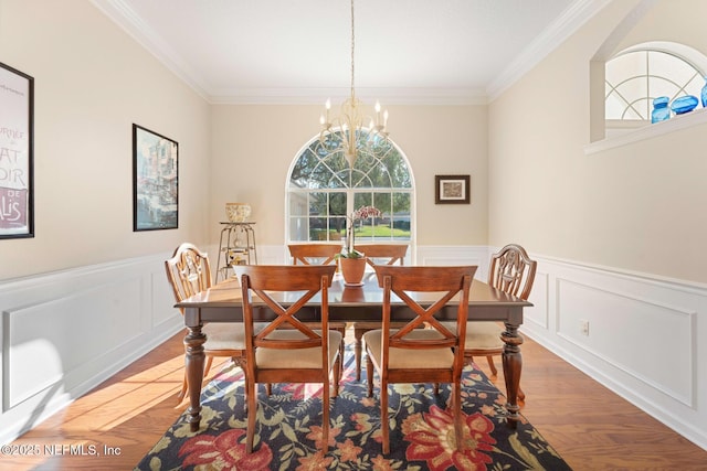 dining space featuring hardwood / wood-style flooring, crown molding, and a notable chandelier