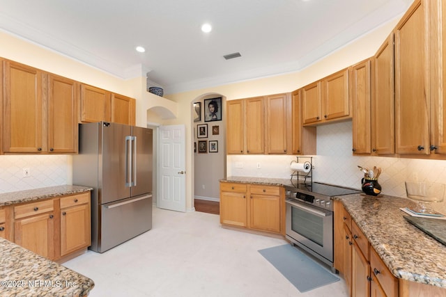 kitchen featuring backsplash, light stone countertops, crown molding, and stainless steel appliances