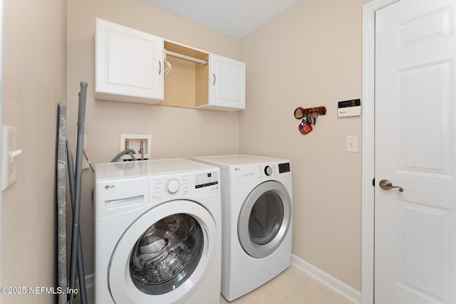 washroom featuring cabinets and independent washer and dryer