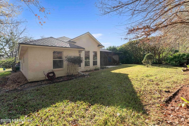 rear view of house featuring a yard