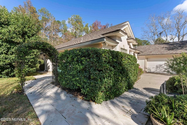 view of side of property featuring a garage