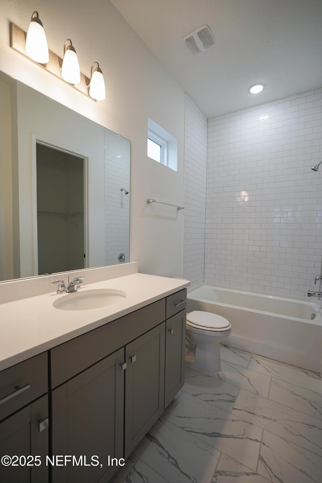 full bath with visible vents, toilet, vanity, marble finish floor, and shower / bathtub combination