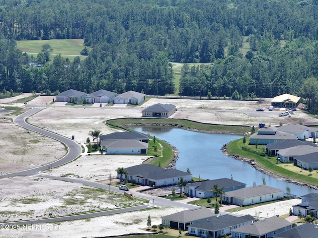 bird's eye view with a forest view, a water view, and a residential view