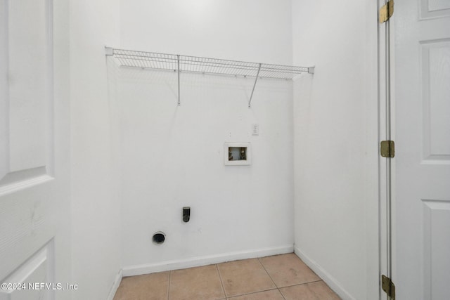 clothes washing area with washer hookup, light tile patterned floors, and electric dryer hookup