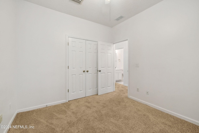 unfurnished bedroom featuring a closet and carpet