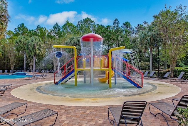 view of jungle gym featuring a community pool