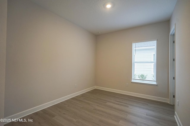 empty room with hardwood / wood-style flooring