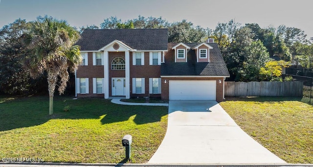 view of front of home featuring a front yard and a garage