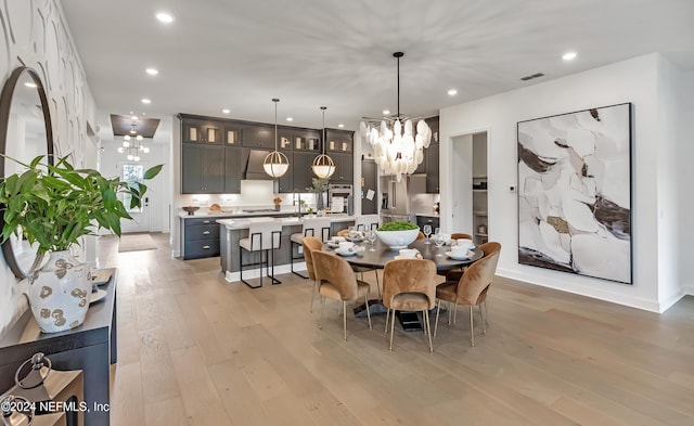 dining area with a chandelier, recessed lighting, visible vents, and light wood-style floors