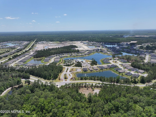 birds eye view of property featuring a water view and a forest view