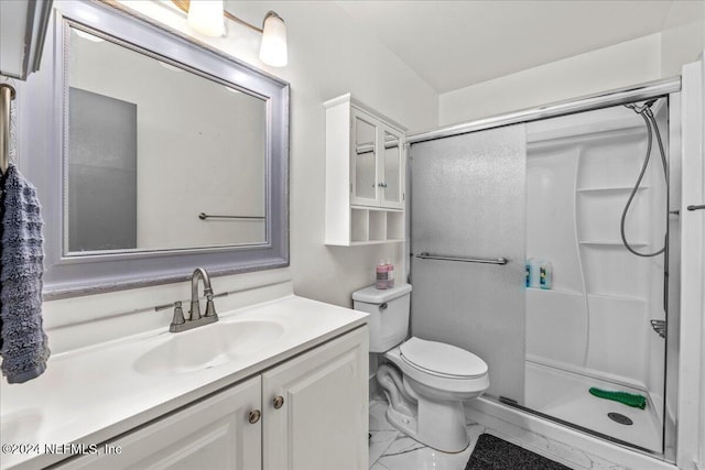 bathroom featuring toilet, vanity, and walk in shower