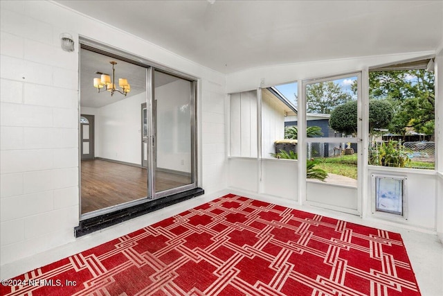 unfurnished sunroom with lofted ceiling and a notable chandelier