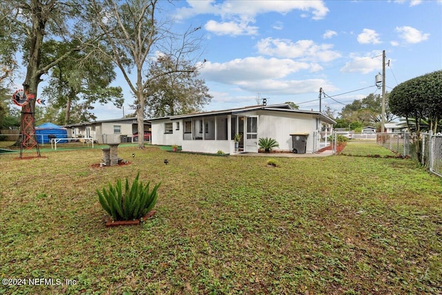 rear view of house with a lawn