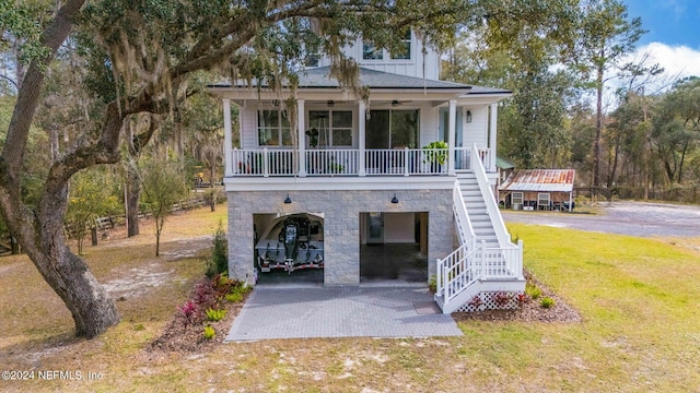 view of front of house with a front yard, a carport, and covered porch