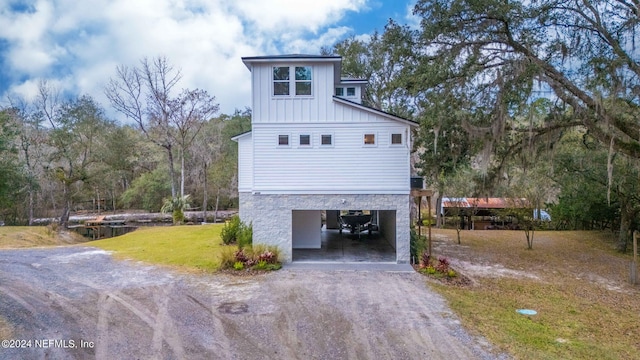 view of side of home with a carport and a lawn