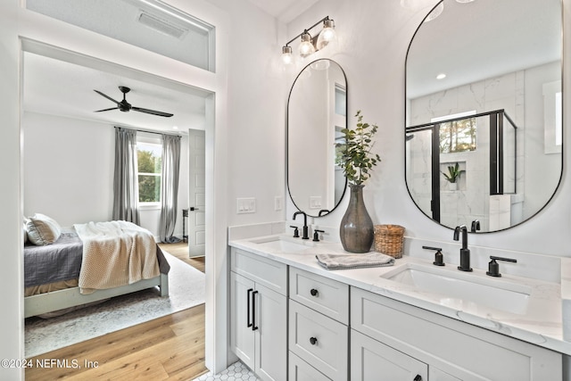 bathroom featuring hardwood / wood-style floors, vanity, ceiling fan, and a shower with shower door