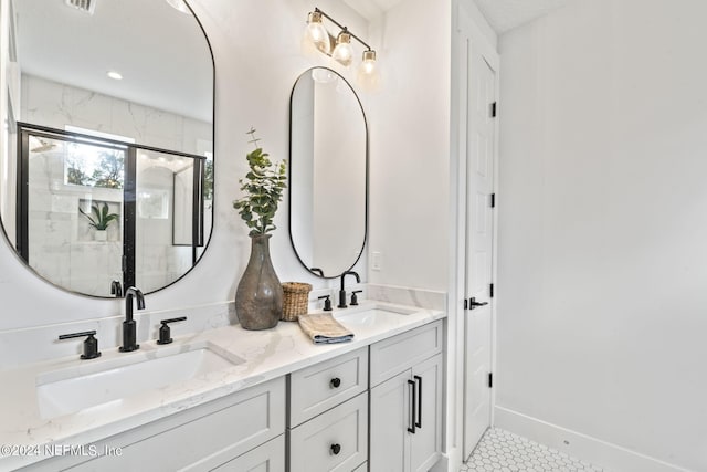 bathroom with a shower with shower door and vanity