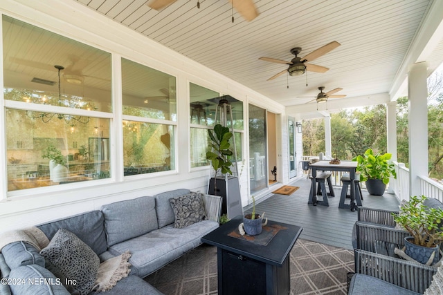 sunroom / solarium featuring ceiling fan