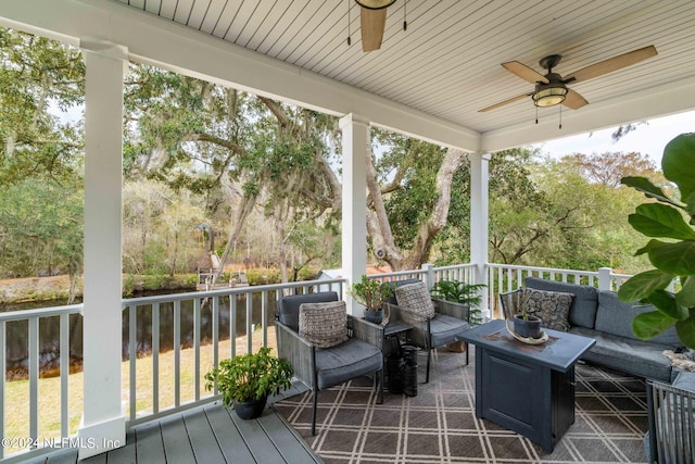 deck featuring ceiling fan and an outdoor living space