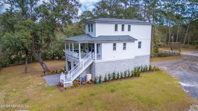 view of front of property with a porch and a front lawn