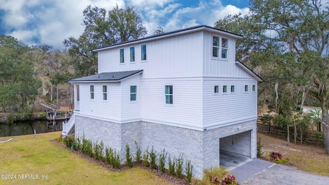 view of side of home featuring a garage and a yard