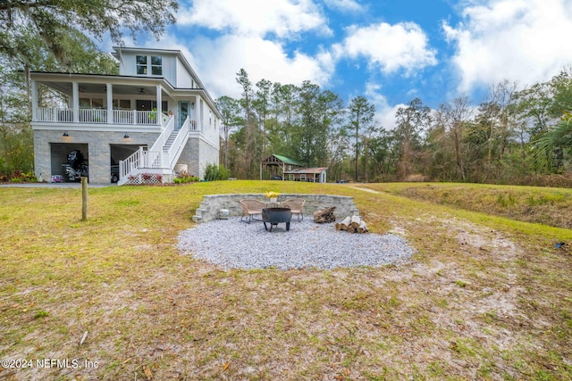 view of yard featuring a fire pit and ceiling fan