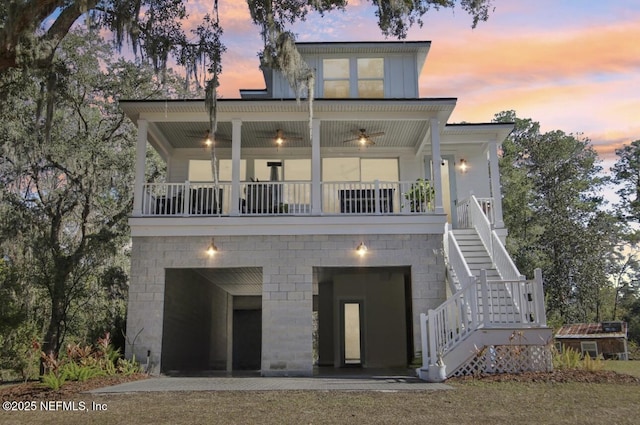 back house at dusk featuring a balcony