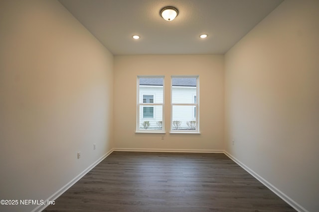 empty room featuring dark wood-type flooring