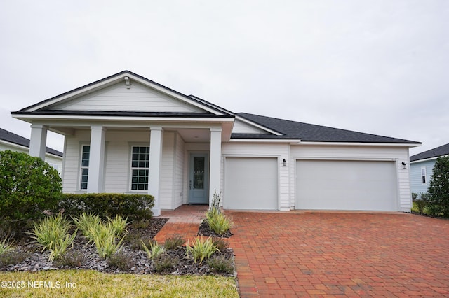 view of front of property featuring a porch and a garage