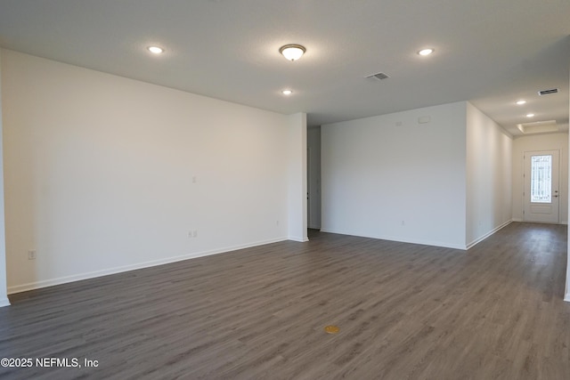 spare room featuring dark wood-type flooring