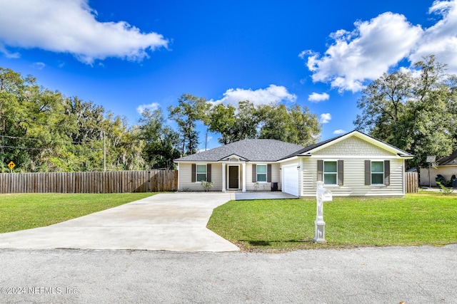 single story home featuring a garage and a front lawn