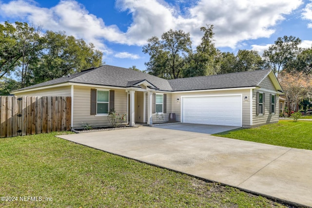 ranch-style house featuring a front lawn and a garage