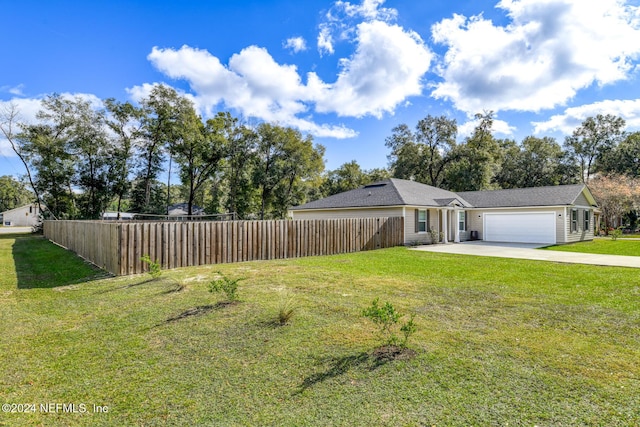 ranch-style house featuring a garage and a front lawn