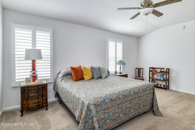 bedroom featuring ceiling fan, light carpet, and vaulted ceiling