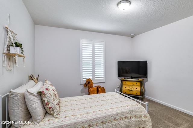 bedroom with carpet floors and a textured ceiling