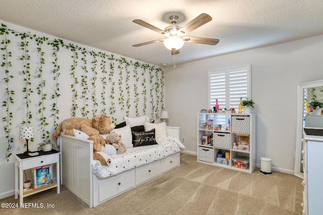 interior space featuring light carpet, a textured ceiling, and ceiling fan