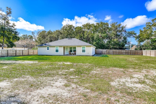 back of property featuring a yard