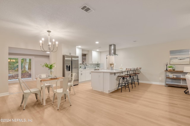 dining space featuring a chandelier and light hardwood / wood-style flooring