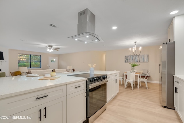 kitchen with white cabinets, island range hood, light hardwood / wood-style floors, and appliances with stainless steel finishes