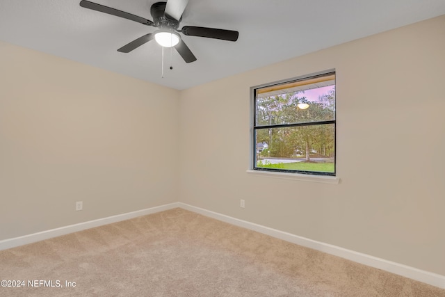 unfurnished room featuring light carpet and ceiling fan