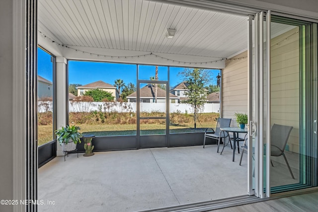 sunroom featuring rail lighting