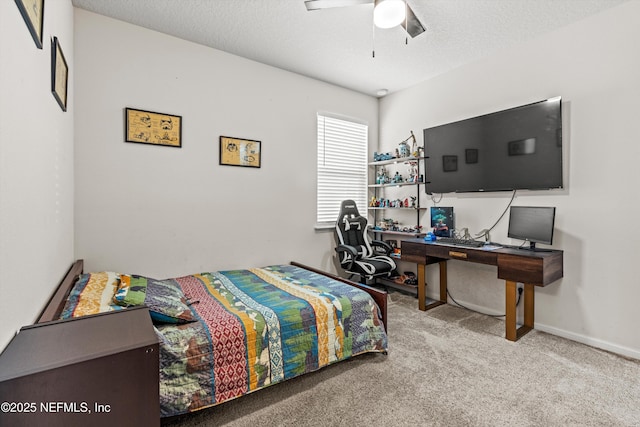 bedroom featuring a textured ceiling, ceiling fan, and light carpet