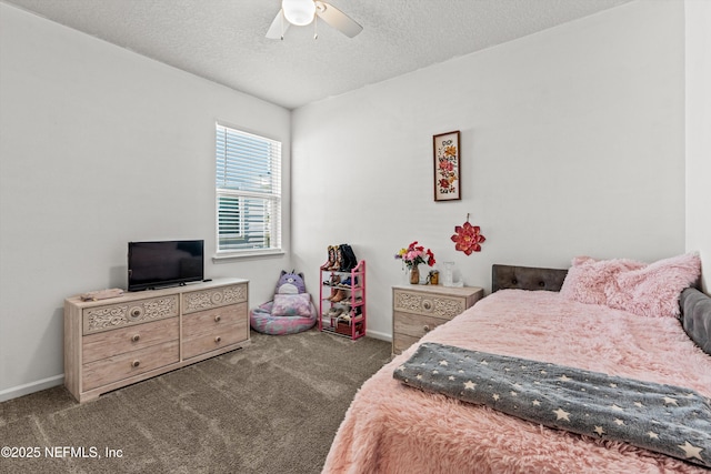 bedroom with a textured ceiling, dark carpet, and ceiling fan