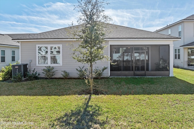 rear view of property featuring a lawn, a sunroom, and cooling unit