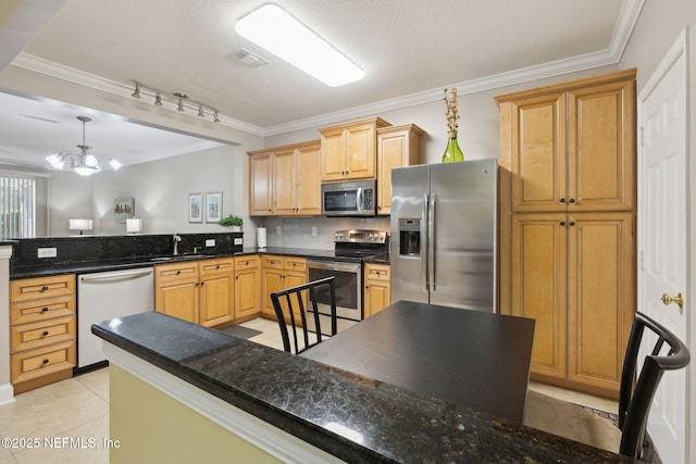 kitchen featuring decorative light fixtures, a notable chandelier, dark stone counters, crown molding, and appliances with stainless steel finishes